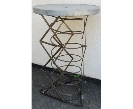 An unusual bistro type table, the circular galvanised top raised on a sprung concertina base (with rise and fall movement) 10