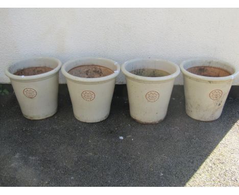 Four good quality glazed ceramic garden planters, each with stylised roundel motifs, each 35cm high, 38cm high (4)