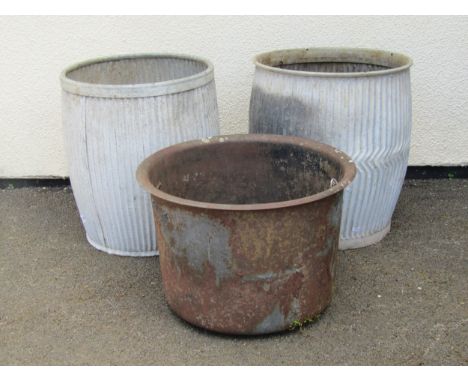 An old ironwork hopper / planter of circular form with flared rim, raised on short feet, 35cm high, 53cm diameter, together w