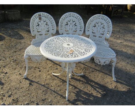 A decorative painted cast metal three seat garden bench with pierced scrolling back over a shaped gridwork seat raised on swe