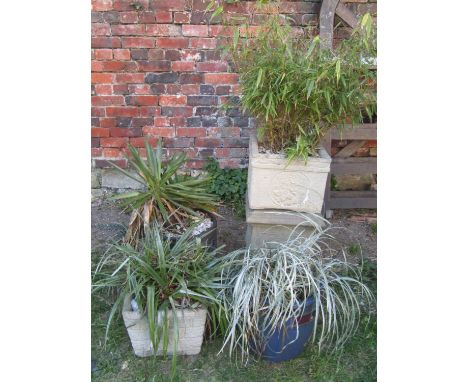 A weathered cast composition stone square garden planter, with floral pattern detail raised on a loose associated pedestal, t