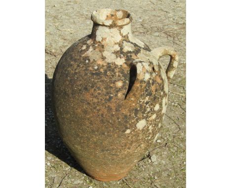 An old weathered Mediterranean terracotta olive jar with loop handles, 53cm high (AF)