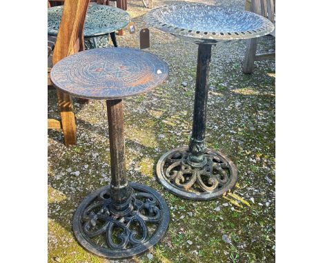 A small weathered painted metalwork bird bath with pierced circular bowl raised on a tapering column and pierced cast metal b