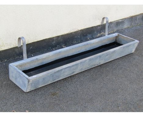 A galvanised wall hanging planter / trough of rectangular form, 14cm high, 126 x 29cm (excluding hooks)