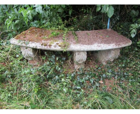 A weathered composition stone bench with curved seat and moulded supports, 38cm high, 133cm wide.