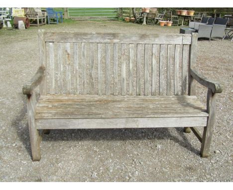 A Bridgman weathered (silvered)  teak three seat garden bench with curved slatted seat and back (af) 153 cm wide 