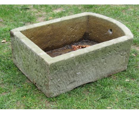 A weathered carved natural D end stone trough, 25cm high x 72cm x 49cm