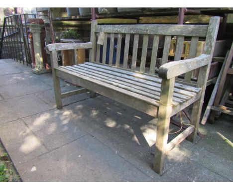A weathered teak two seat garden bench, 122cm wide