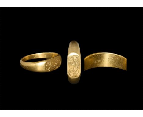 15th century AD. A D-section gold hoop with flattened plaque, incised image of St Catherine nimbate, beside a chiaro oscuro s