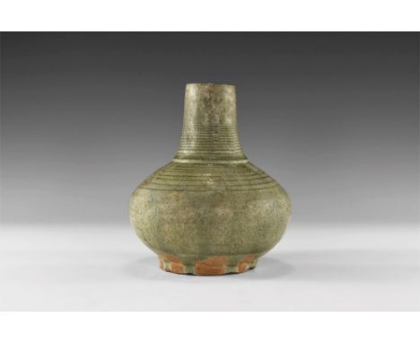 14th-16th century AD. A green glazed Sangkhalok Celadon ware spouted vase with long tapering neck and globular body, both wit