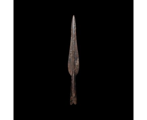 8th-9th century AD. An iron spearhead with undulating profile to the blade, shallow midrib, expanding socket with closed sock