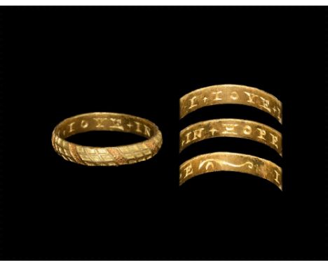 16th century AD. A gold band ring with cells of oblique squares divided by band of red gold with leaf pattern; to the inside 