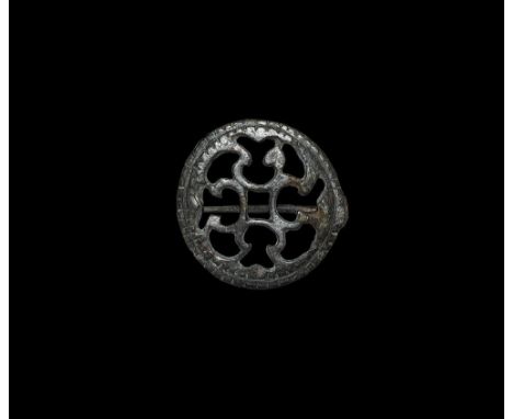 2nd century AD. A flat-section disc brooch with notched edge, openwork pattern of scrolls, hinged pin and catchplate to the r