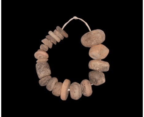 Neolithic, 6th-4th millennium BC. A mixed group of twenty modelled pottery beads of rounded and disc form. 230 grams total, 1