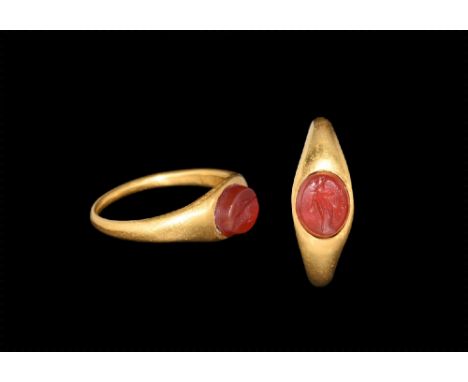 1st-3rd century AD.
A gold ring with tapering shank, bezel set with an intaglio engraved with the figure of a standing goddes