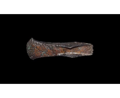 20th-13th century BC. An iron palstave axe head with slightly spatulate blade, a pair of raised triangular lateral wings form