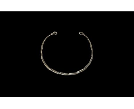 1st century BC-1st century AD.
A penannular torc formed from three round-section silver rods, terminals formed as addorsed sw