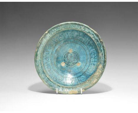 11th-12th century AD.
A broad ceramic turquoise-glazed bowl with narrow fot, carinated bowl, flared rim; central black leaf m