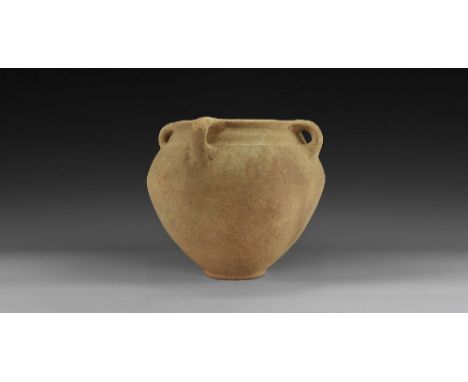 8th century BC. A ceramic vessel with biconvex profile, broad shoulder, flat everted rim, four radiating strap handles; with 