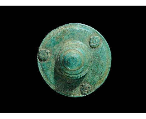 1st century AD. A bronze phalera military mount comprising a discoid plaque with incised concentric lines and three studs wit