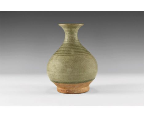 14th-16th century AD. A green glazed Sangkhalok Celadon ware vase with flaring mouth, narrow neck, bulbous body with ribbing 