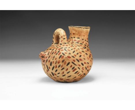 1st millennium AD. A ceramic askos with squat body, tubular filling neck with slightly flared rim, loop handle and stub spout