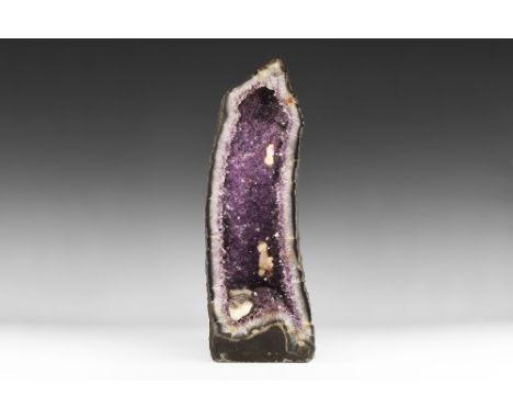 A large amethyst geode section with well-formed and richly coloured amethyst crystals, with several well-formed secondary lar