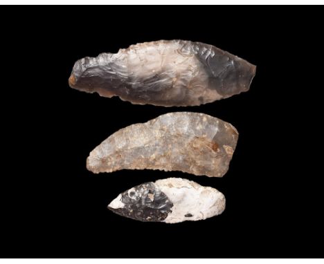 Neolithic, 5th-3rd millennium BC. A group of knapped bifacial flint tools comprising: a curved sickle with serrated cutting e