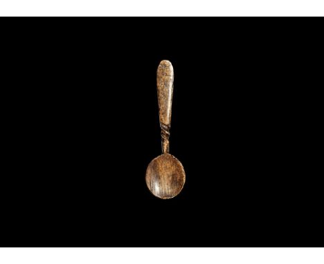 14th-16th century AD. A bone miniature spoon with flat-section stem and shallow discoid bowl, carved twist above the bowl. 2.