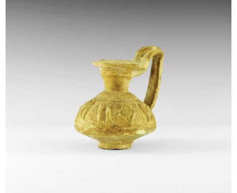 1st millennium BC. A ceramic biconical jug with flared base, funicular neck and flange rim, strap handle to the rear; band of