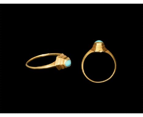 13th-14th century AD. A cusped D-section gold hoop with expanding shoulders, octagonal bezel with stepped sides, inset turquo