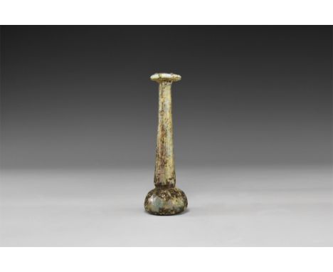 1st-3rd century AD. A glass toilet bottle with bulb finial, dimple base, tapering stem, everted and rolled rim; iridescent su
