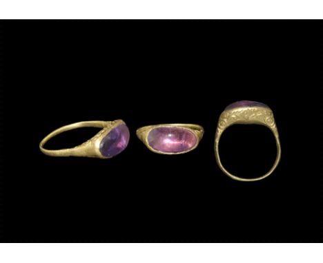14th-15th century AD. A gold D-section hoop with flared shoulders, elliptical bezel with scrolled tendrils and median lozenge