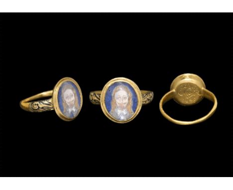 Mid-17th century AD. A gold band ring with black enamelled scrolling decoration to the shoulders; round bezel set with enamel