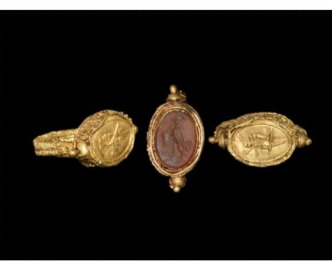 7th-5th century BC.
A flat-section hoop of gold filigree in two parallel bands with collar and granules to each end; swivelli