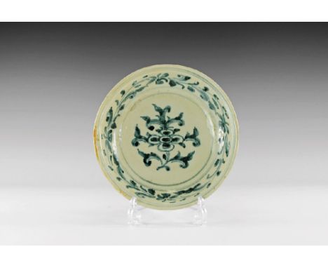 Later 15th century AD. A broad white-glazed ceramic bowl with blue arcading to the outer face, running foliage and tendrils t