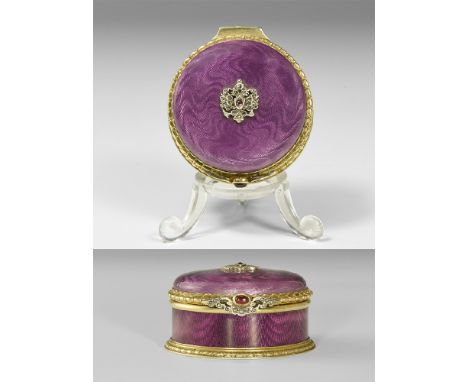 Late 19th-early 20th century AD. A silver-gilt circular box with transluscent mauve enamel over turned 'fabric' background to