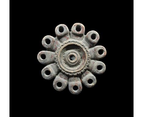 3rd-4th century AD. A ceramic oil lamp comprising a segmented bowl with filler howl to the upper face with rosette and concen