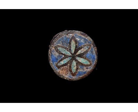 1st-2nd century AD. A round enamel brooch with enamel pattern in blue and green of a six petalled flower; pin and catch plate