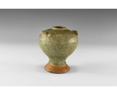 13th-16th century AD. A green glazed Sangkhalok Celadon ware vase with narrow mouth and small rim; globular body with applied