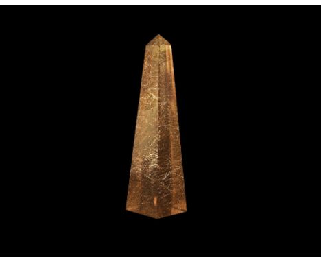 An exceedingly fine obelisk carved from rutilated smoky quartz, with hundreds of fine, hair-like needles of golden rutile sca
