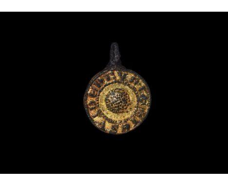 14th-15th century AD. A circular gilt harness pendant with raised pelletted orb at centre and Lombardic '+IE SVI NE DRVRIE' r
