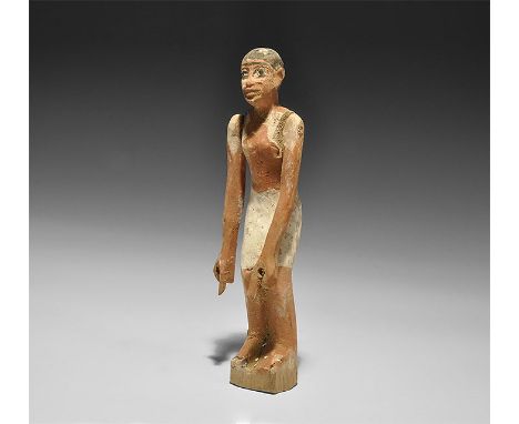 Middle Kingdom, 2055-1650 BC.
A painted wooden figure of a man wearing a loin cloth; with short black hair and eyes outlined 