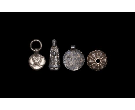 10th-15th century AD. A mixed silver group comprising: a trefoil plaque with pendant ring; a domed cap with granule detailing