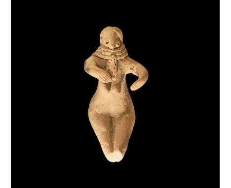 4th-3rd millennium BC. A ceramic figure of a seated female with legs extended forward, arms held forward to the breasts, thic
