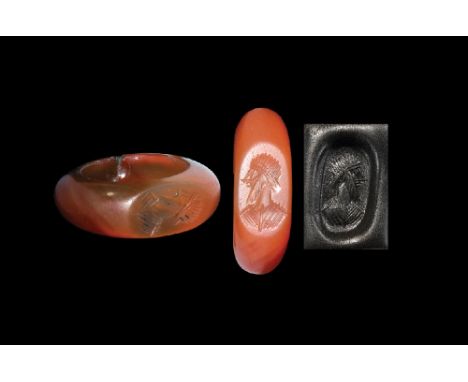 3rd-6th century AD. A carnelian plano convex ring with the bezel engraved with the bust of a bearded male. 4.97 grams, 26.10m