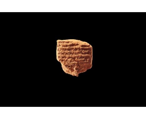 Neo-Assyrian Period, 750-670 BC. A fragment of clay pillow-shaped tablet with cuneiform text; accompanied by manuscript signe