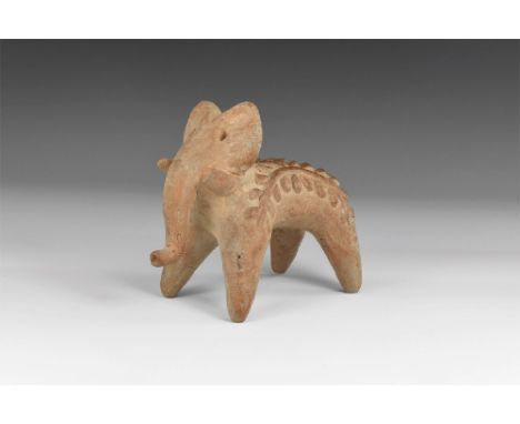 3rd-2nd millennium BC. A ceramic figure of an elephant with arching plant motif to the sides of the body. 219 grams, 12.5cm (