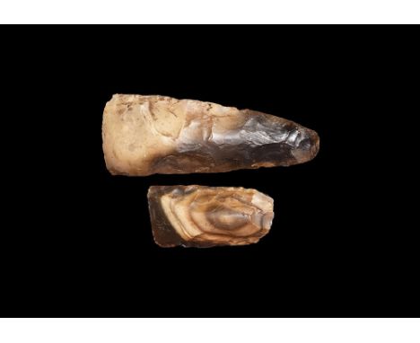 Neolithic, 4th-2nd millennium BC. A mixed pair of polished flint axeheads comprising: one flat in section with tapering sides