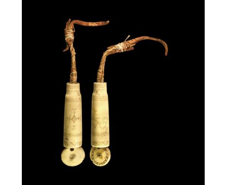 Dated 1912 AD. A tiered bone needle case comprising a bone sleeve truncated at each end with an inner hide sliding compartmen